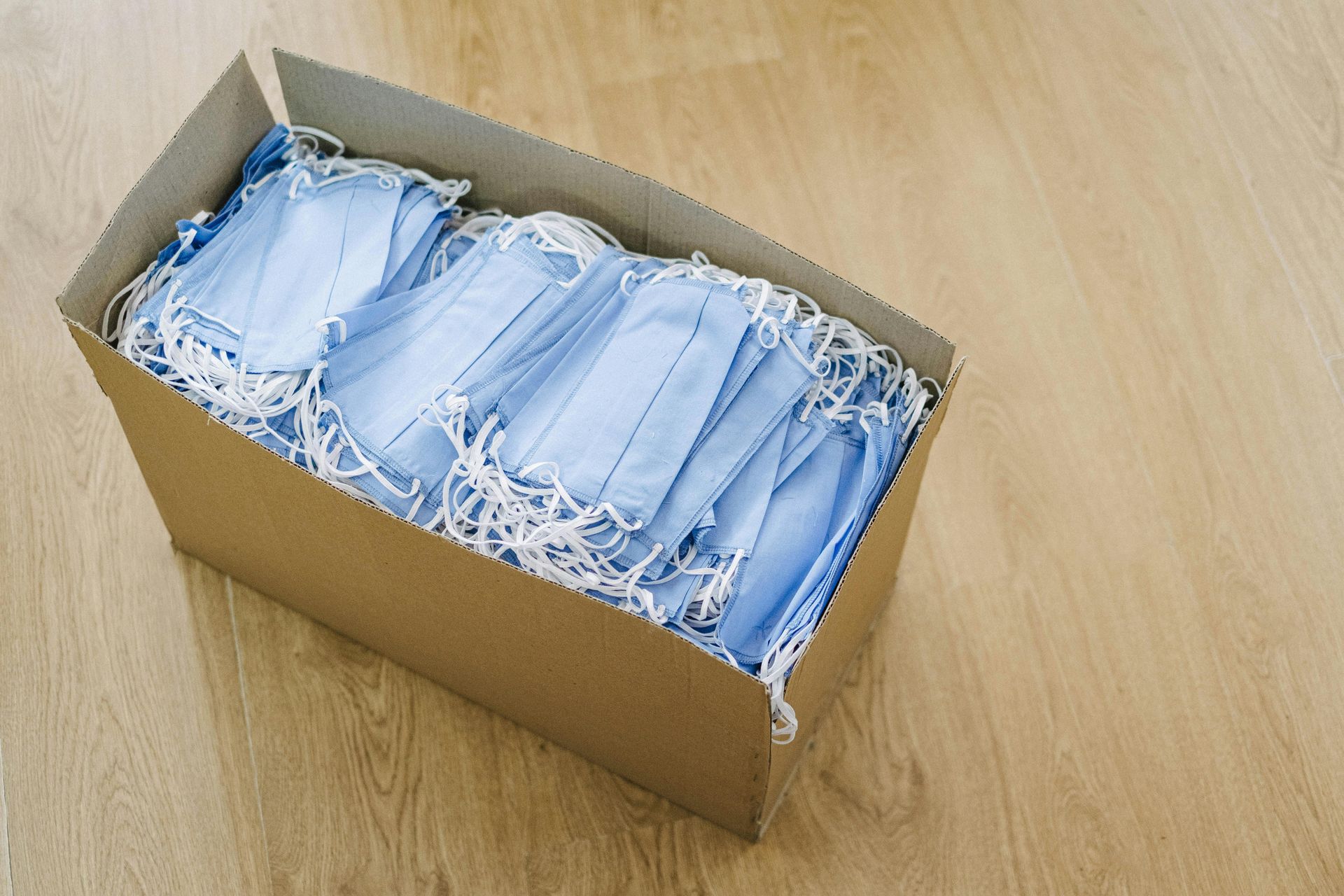 Cardboard box full of surgical masks