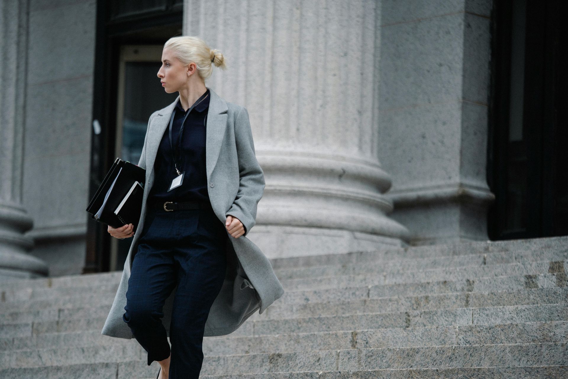 Blonde business woman walking down the steps of a courthouse