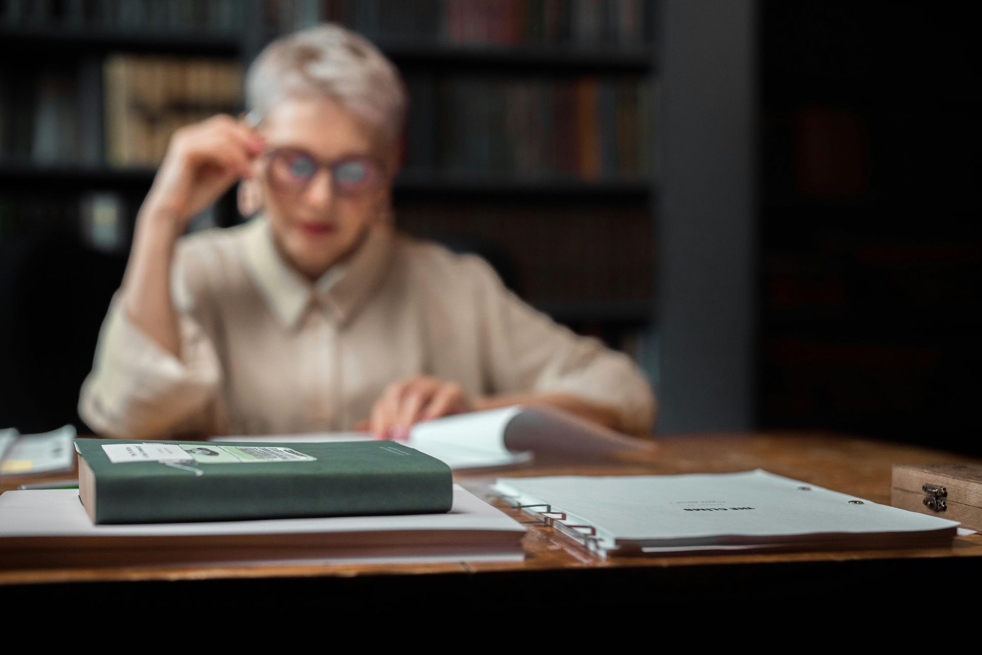 A person sitting in a library reading a book