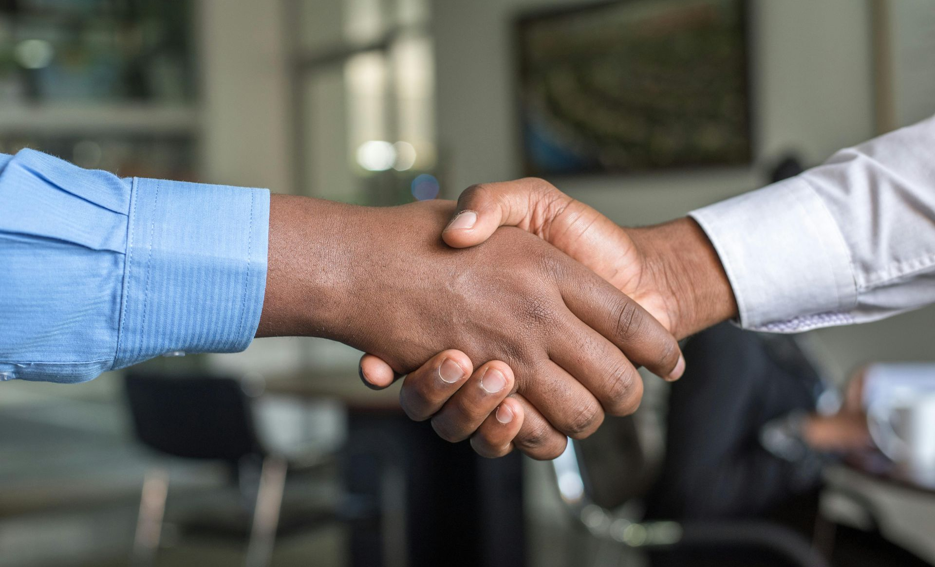 Two men in business shirts shaking hands