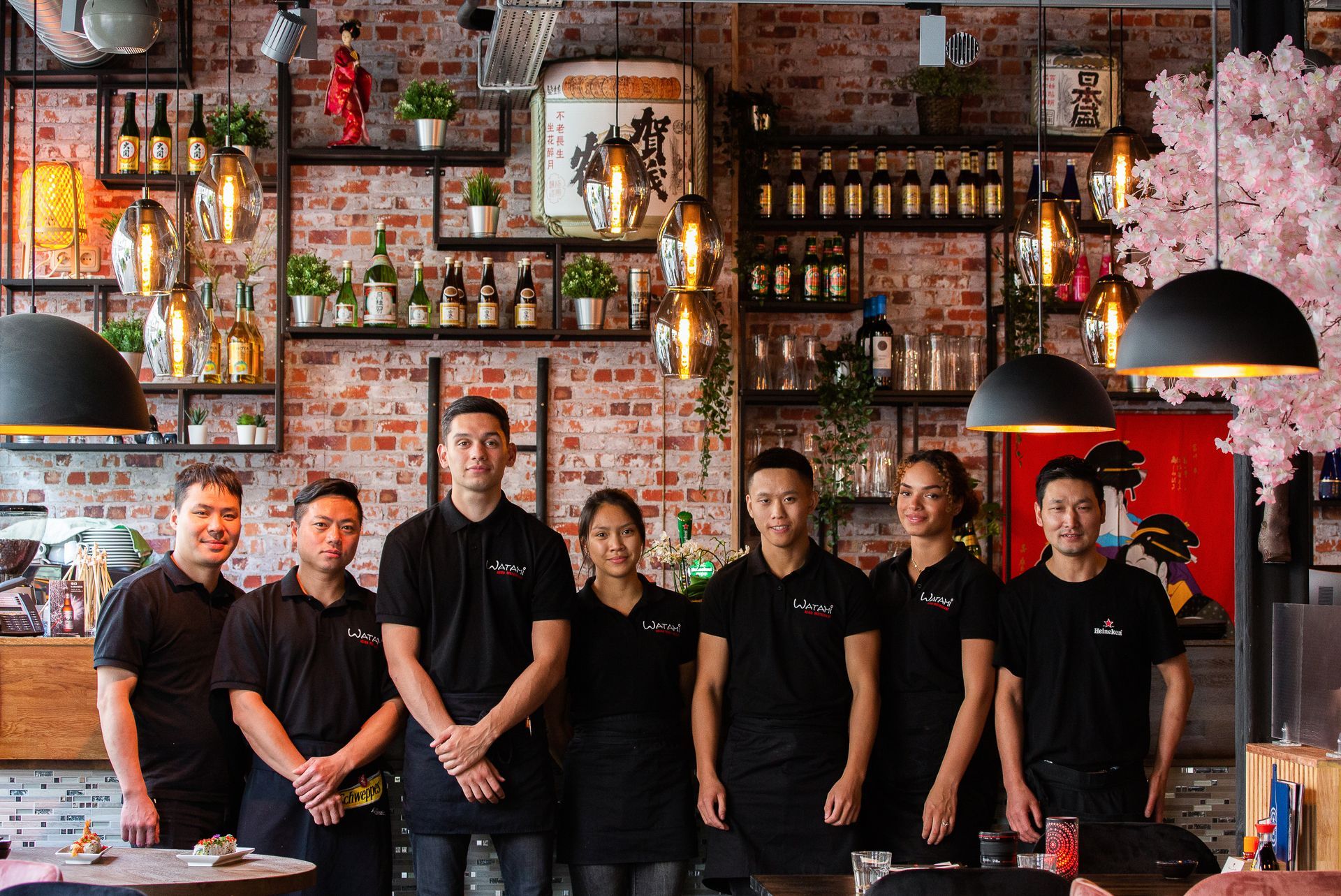 Een groep mensen poseert voor een foto in een restaurant.