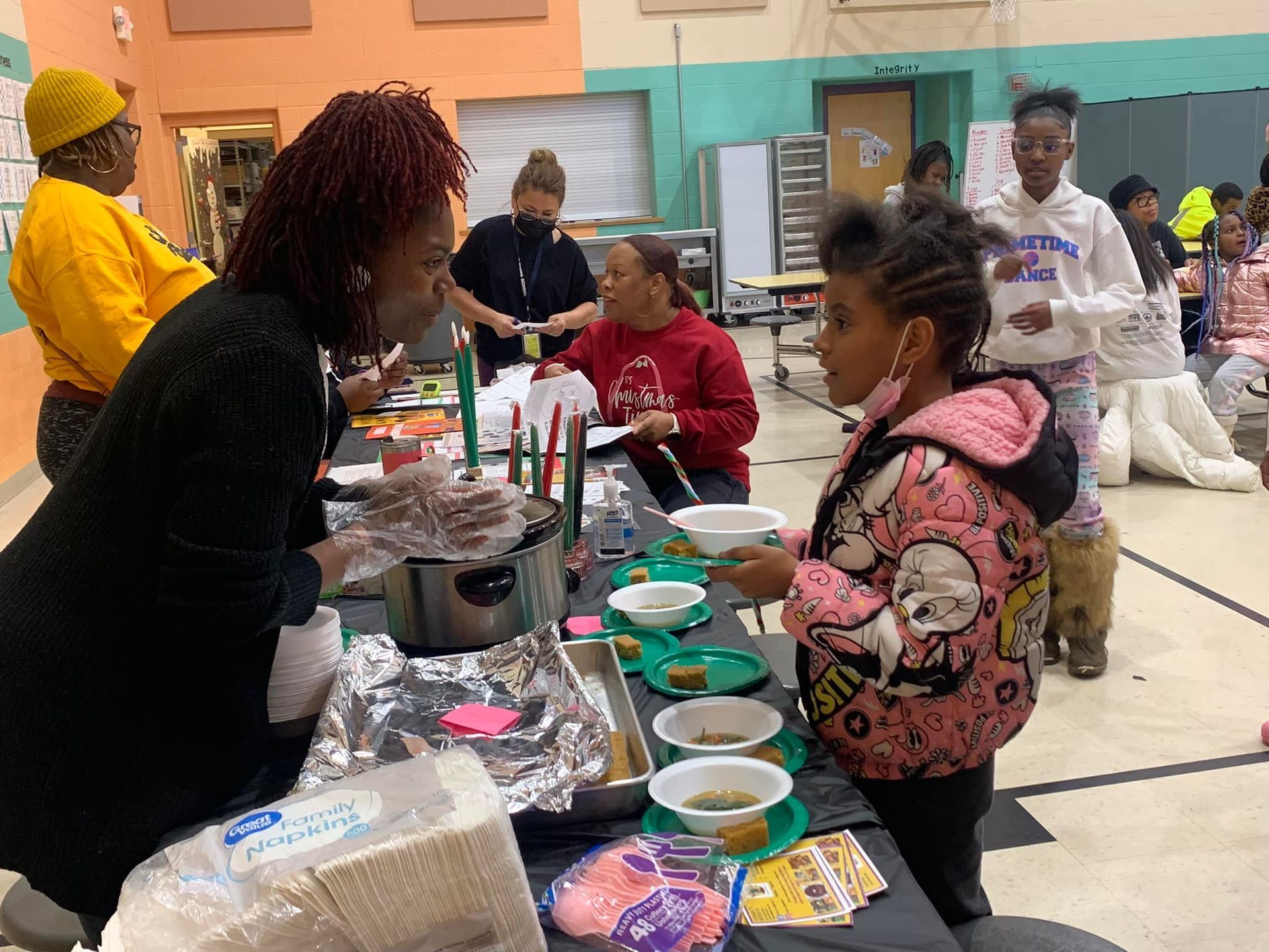 A group of people are sitting around a table eating food.