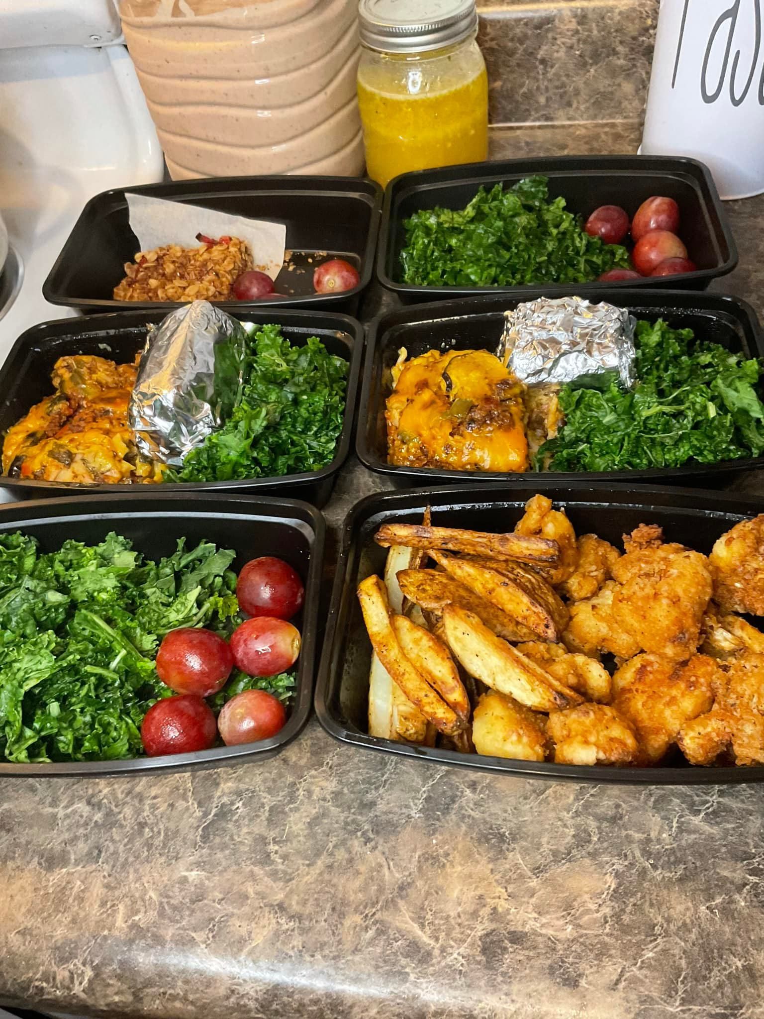 A bunch of containers of food are sitting on a counter.