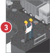 Two men in hard hats are standing next to a dump truck.