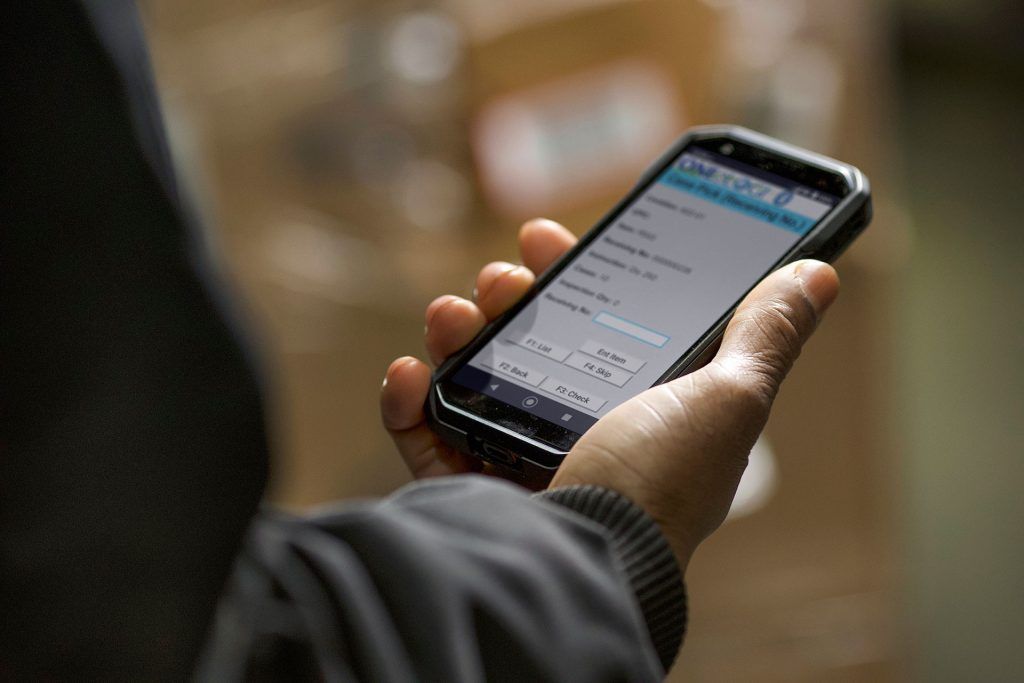 A person is holding a cell phone in their hand