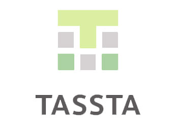 A logo for tassta with a green t and gray squares on a white background.