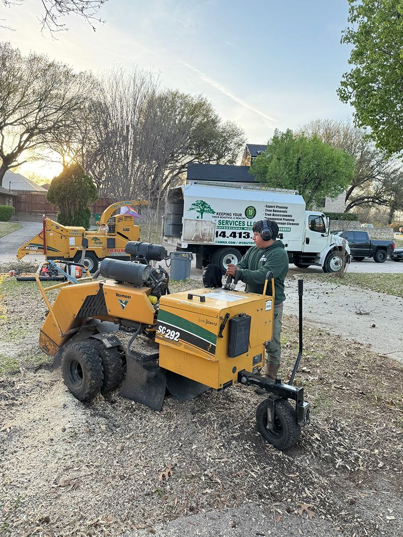 A man is using a stump grinder to remove a tree stump.