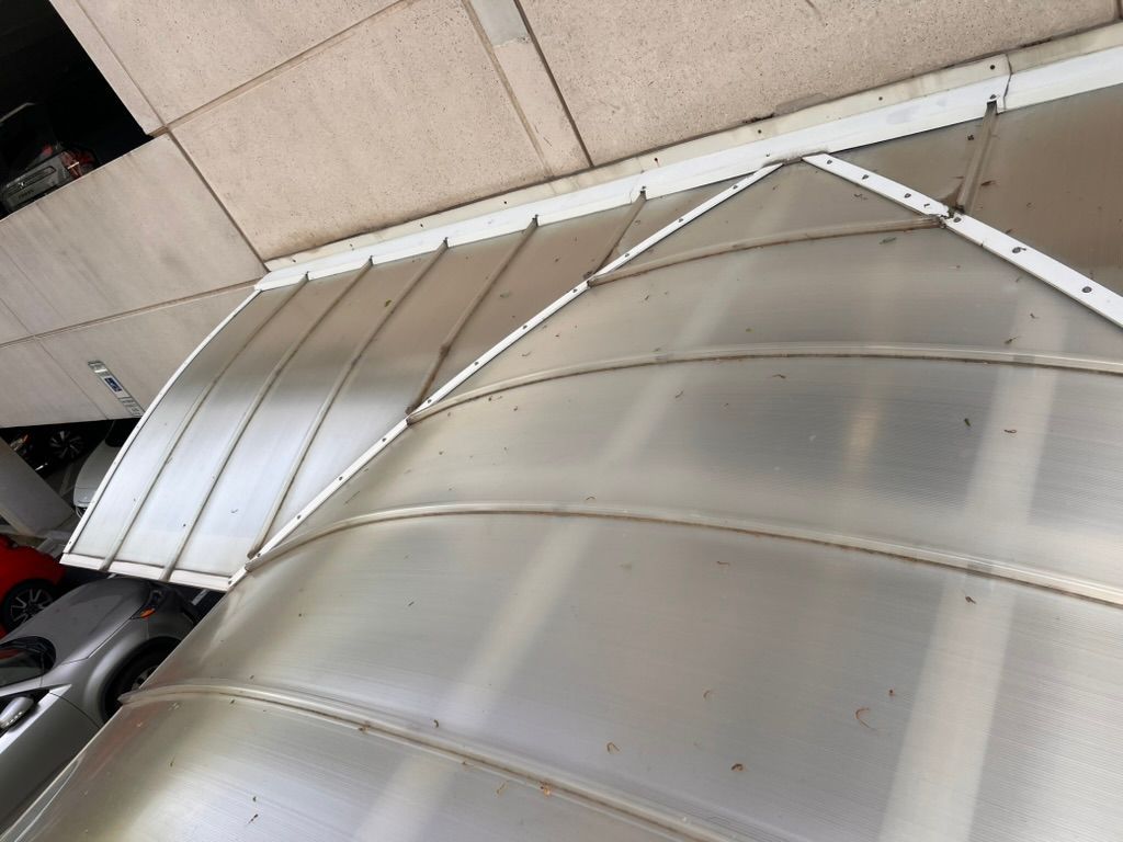 Wooden window shutters, horizontal slats, weathered appearance.