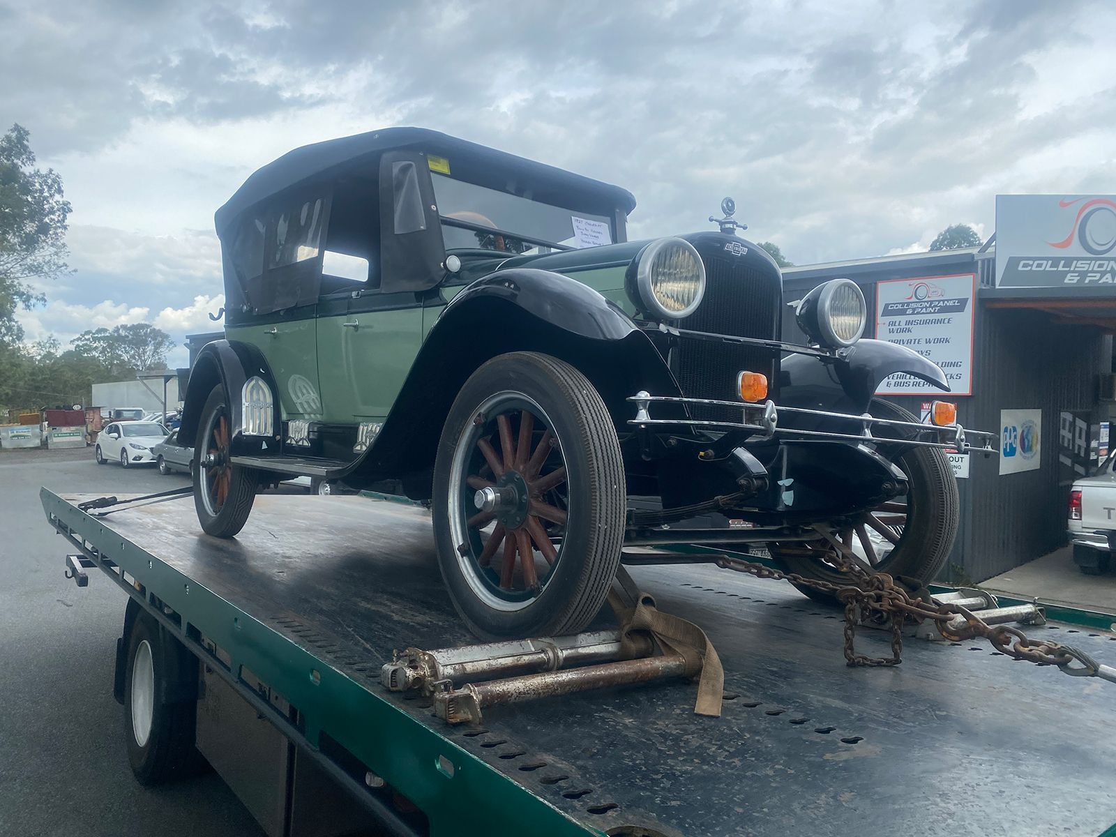 An Old Car is Sitting on Top of a Tow Truck — Taree Tilt Tray Towing In Wingham, NSW
