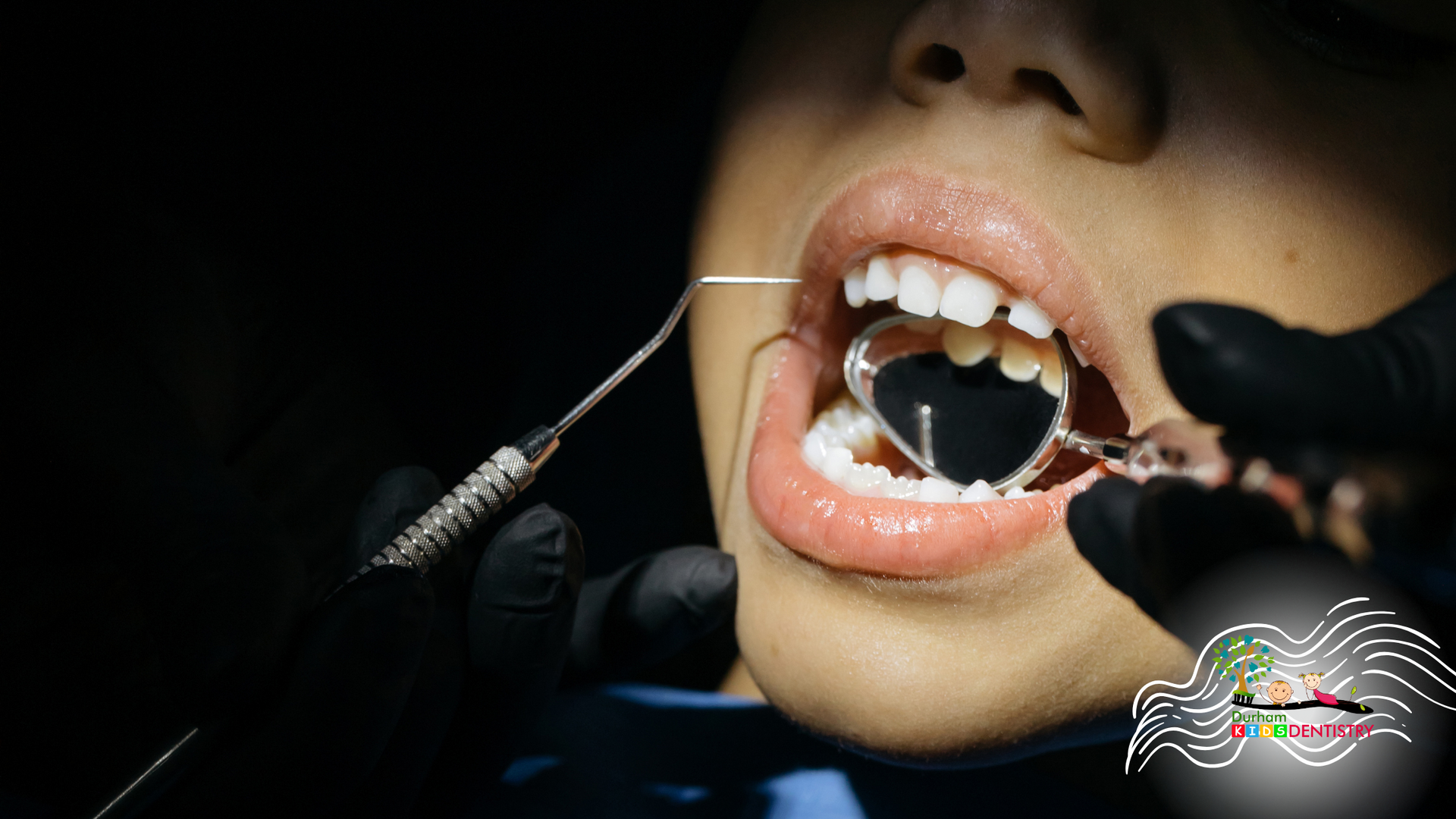 A woman is getting her teeth examined by a dentist.