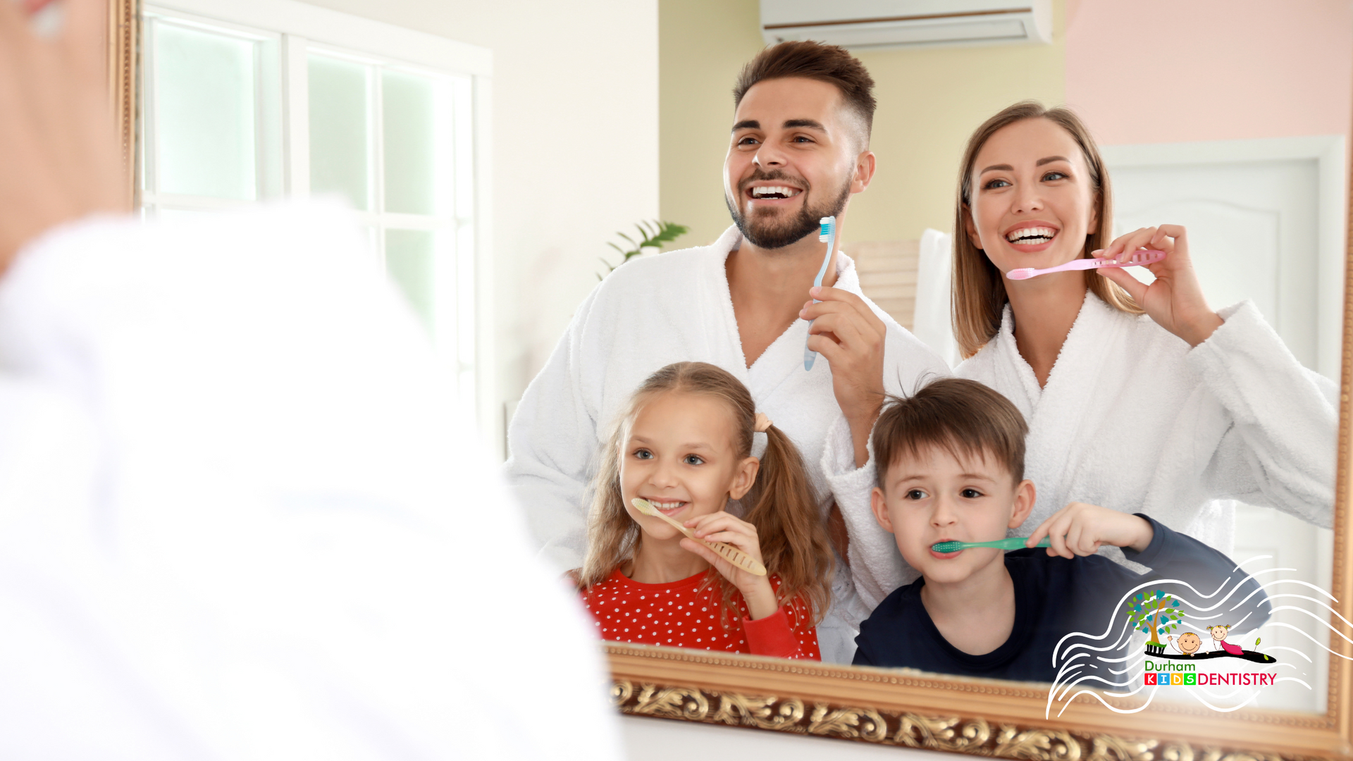 A family is brushing their teeth together in front of a mirror.