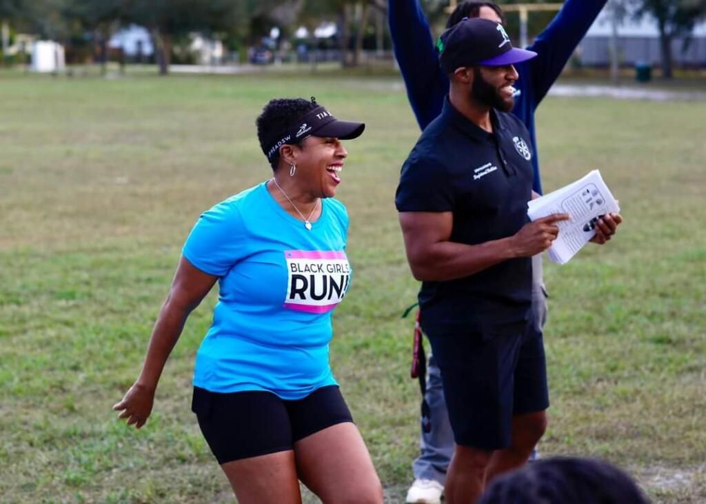 A woman in a blue shirt with the word rum on it