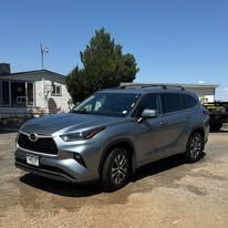 Gray Toyota SUV parked in front of a house on a sunny day.