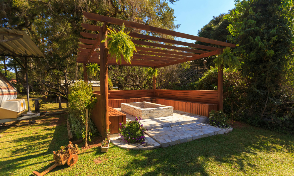 A patio with a fire pit and a couch in front of a house