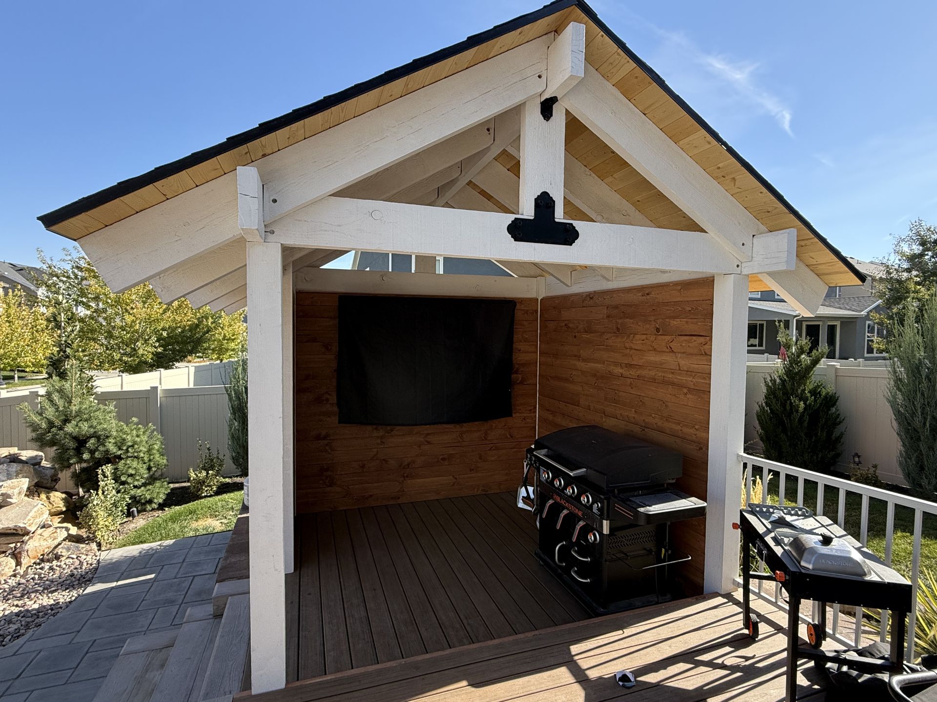 A gazebo with a grill and a flat screen tv