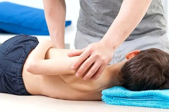 Child Having Chiropractic Back Adjustment | Mermaid Beach, Qld | Dive Chiropractic Centre