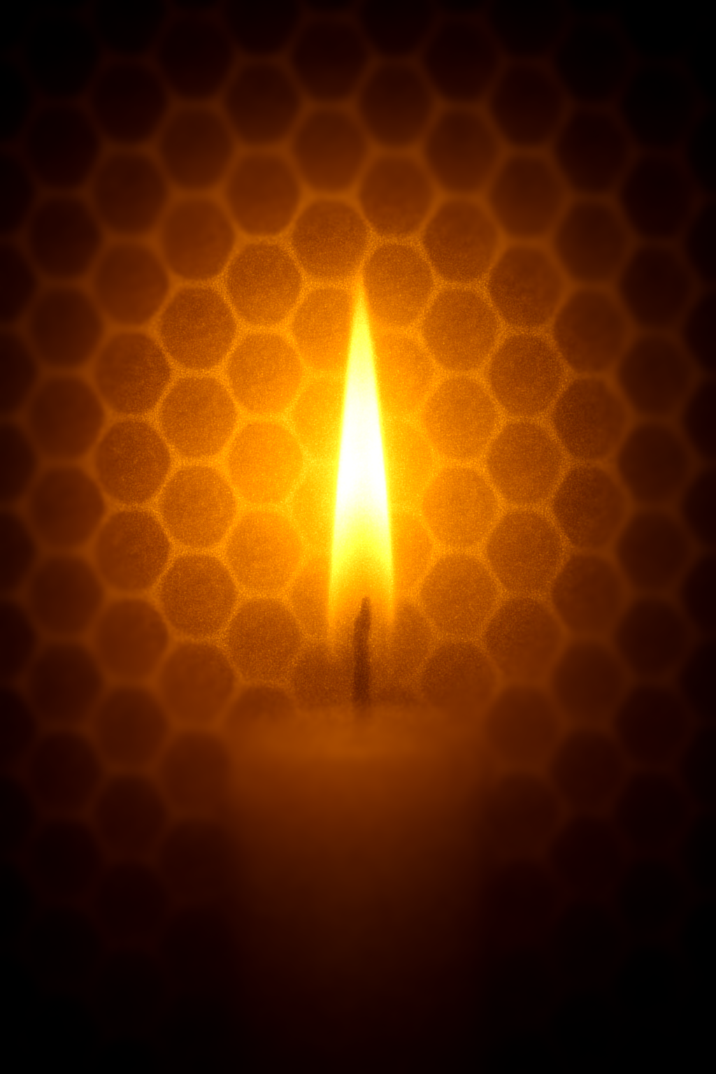 a candle's flame lighting up a background of honey comb