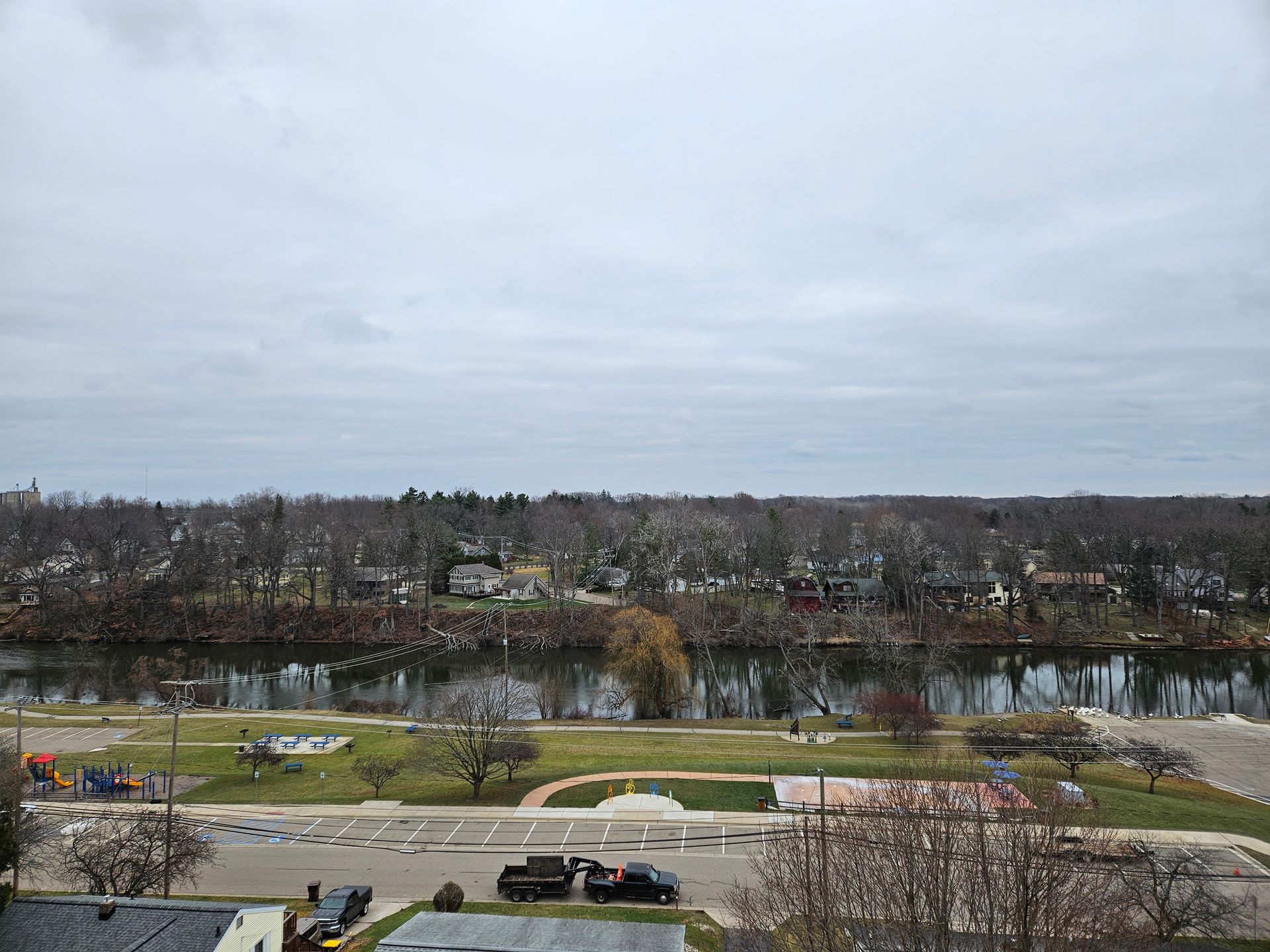 An aerial view of a city with a river in the background.