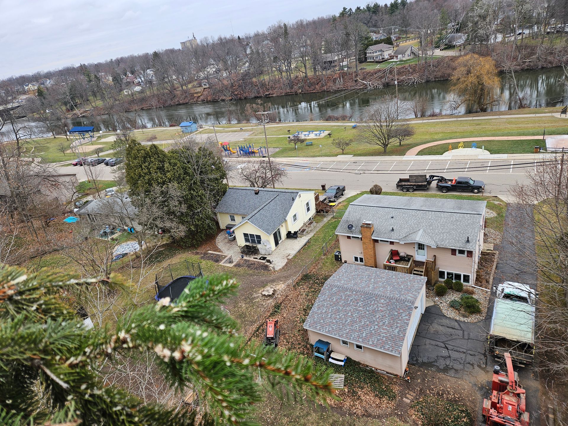 An aerial view of a residential area with a river in the background.