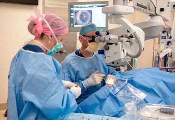 A surgeon is operating on a patient in an operating room.