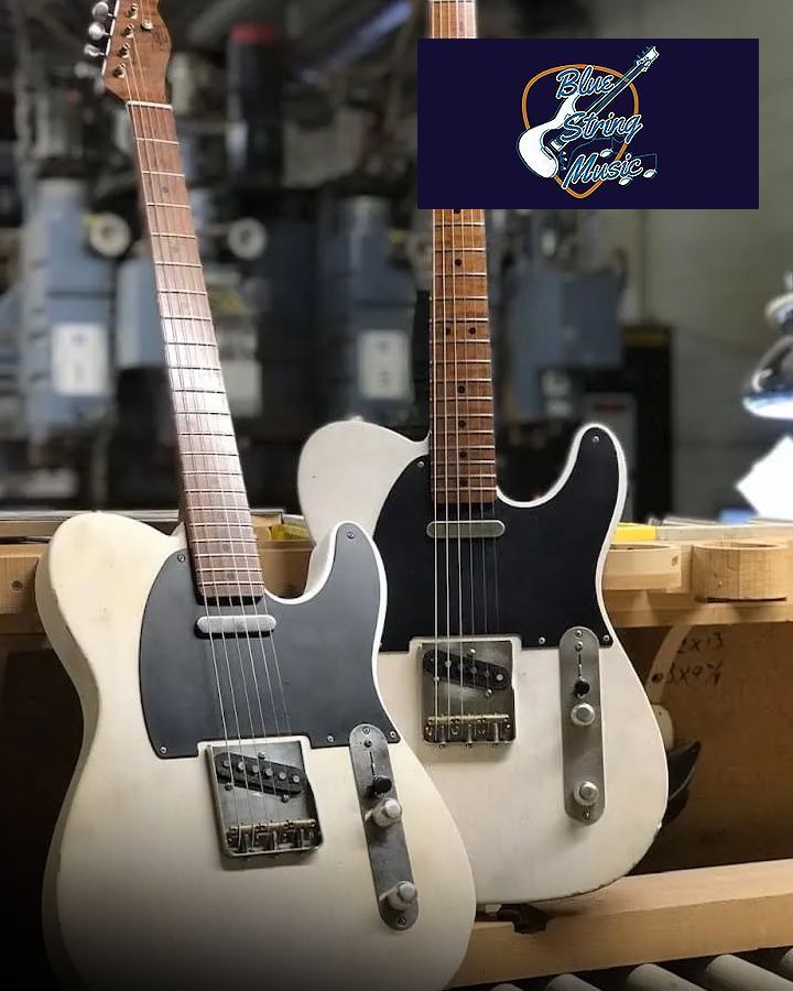 Two electric guitars are sitting next to each other on a table