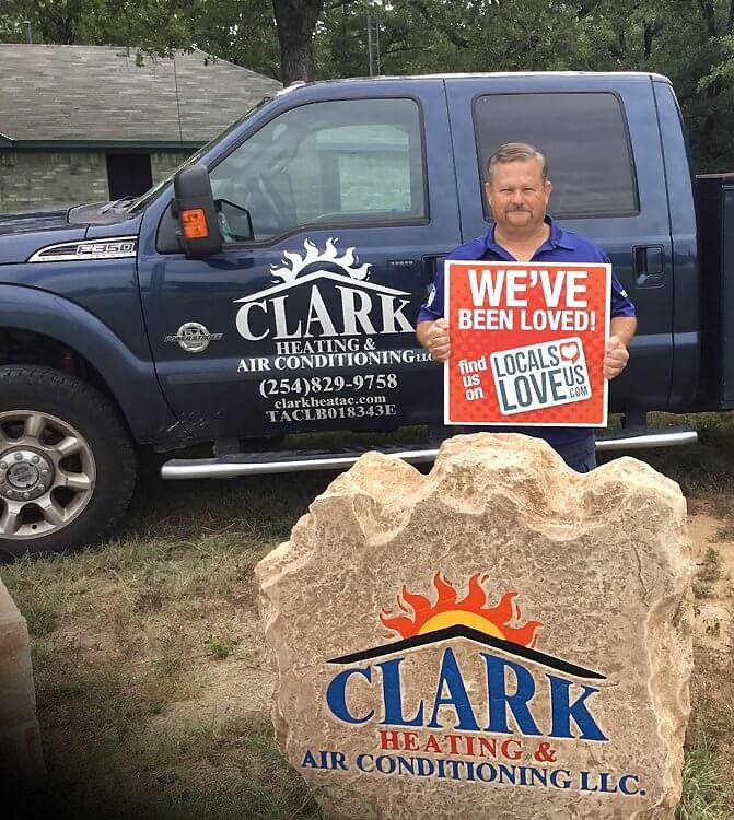 A man is standing in front of a truck holding a sign that says `` we 've been loved ''.