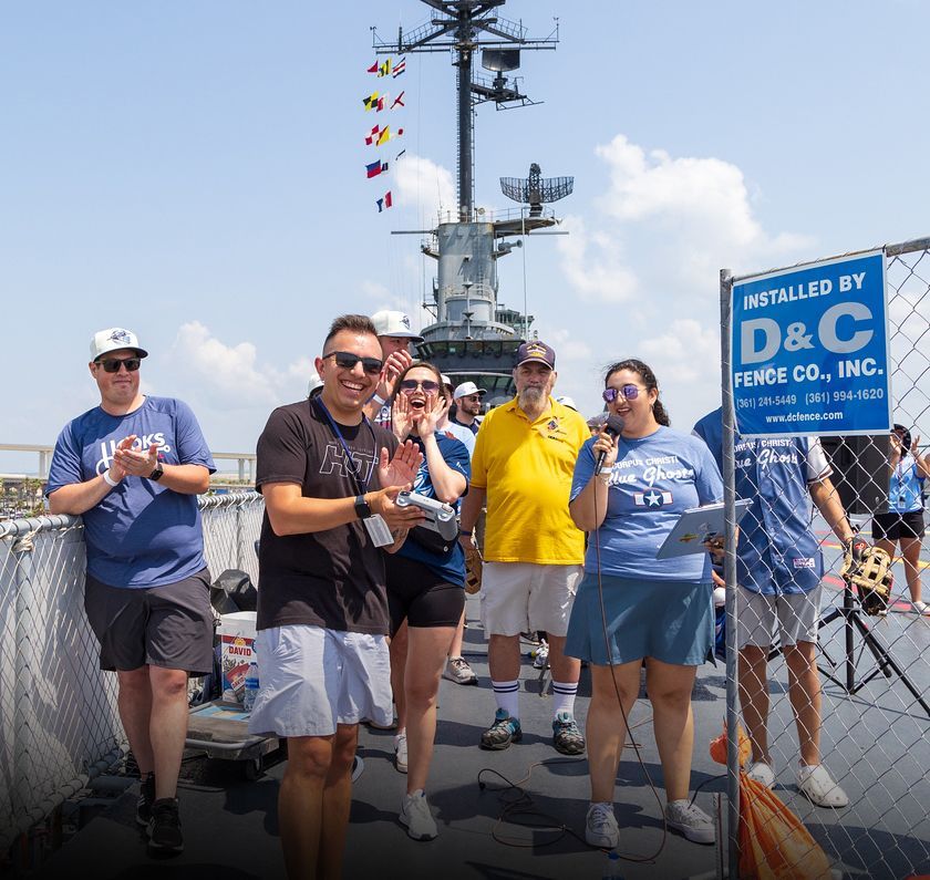 A group of people standing in front of a sign that says d & c