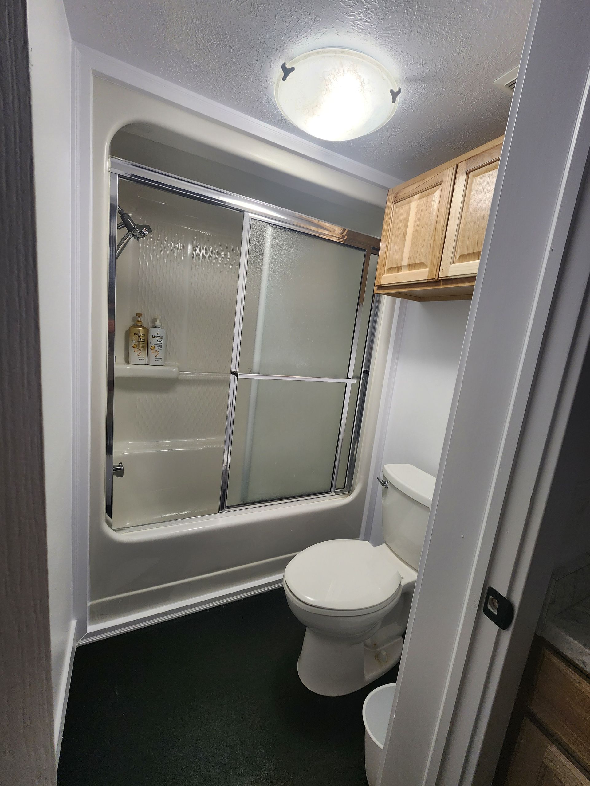 A bathroom with a toilet a tub and a shower