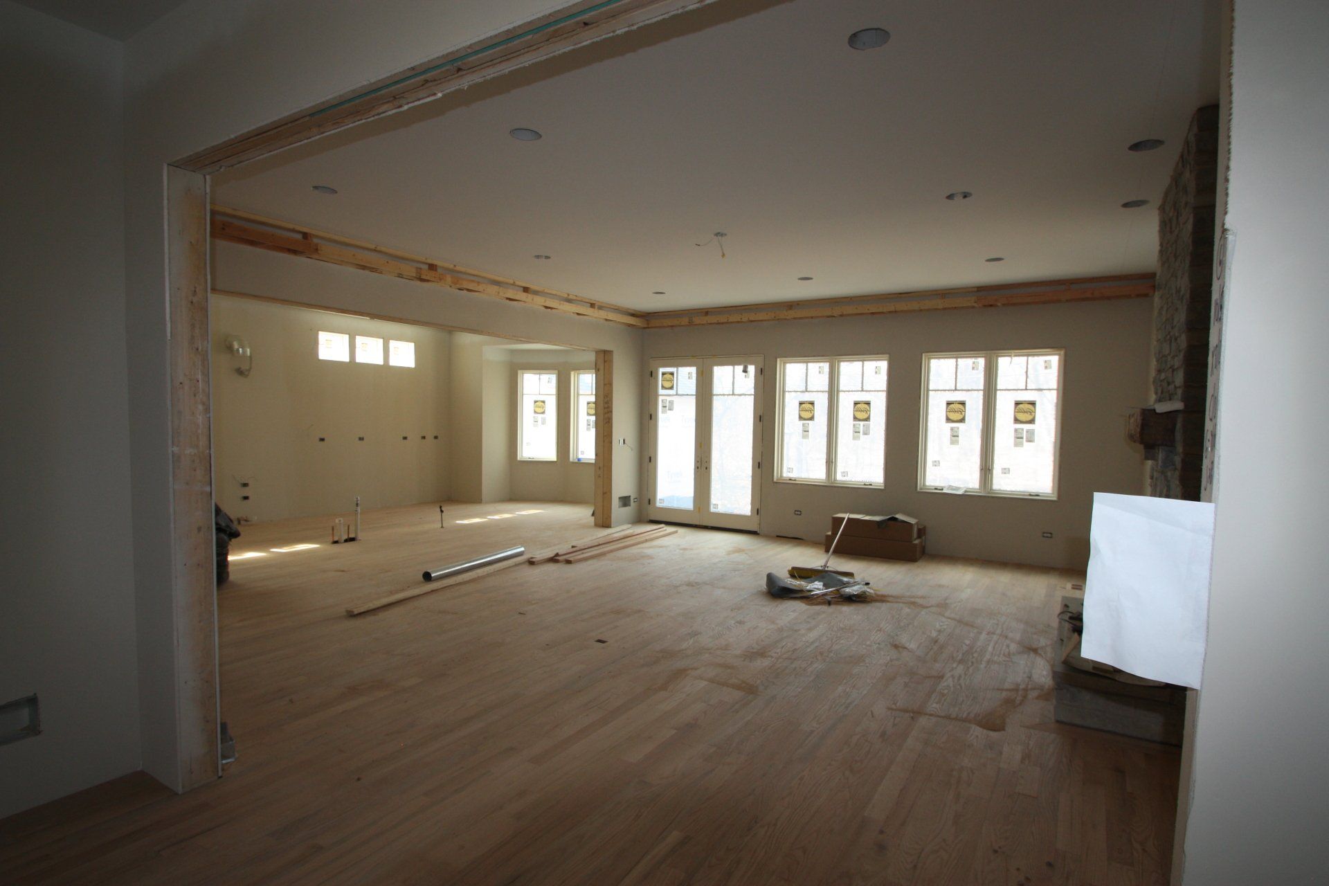 An empty room with a lot of windows and wooden floors