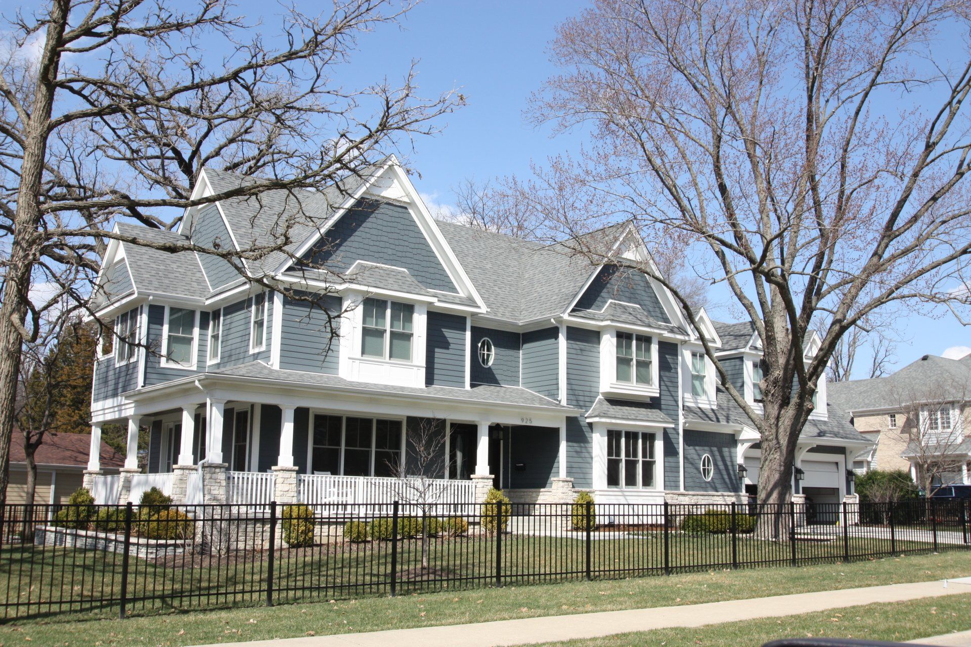 A large white house with a fence around it