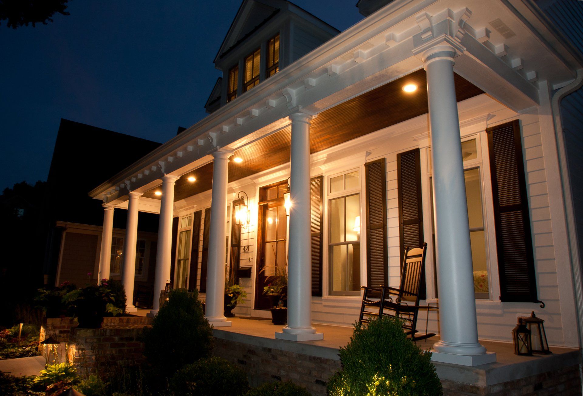 The porch of a house is lit up at night