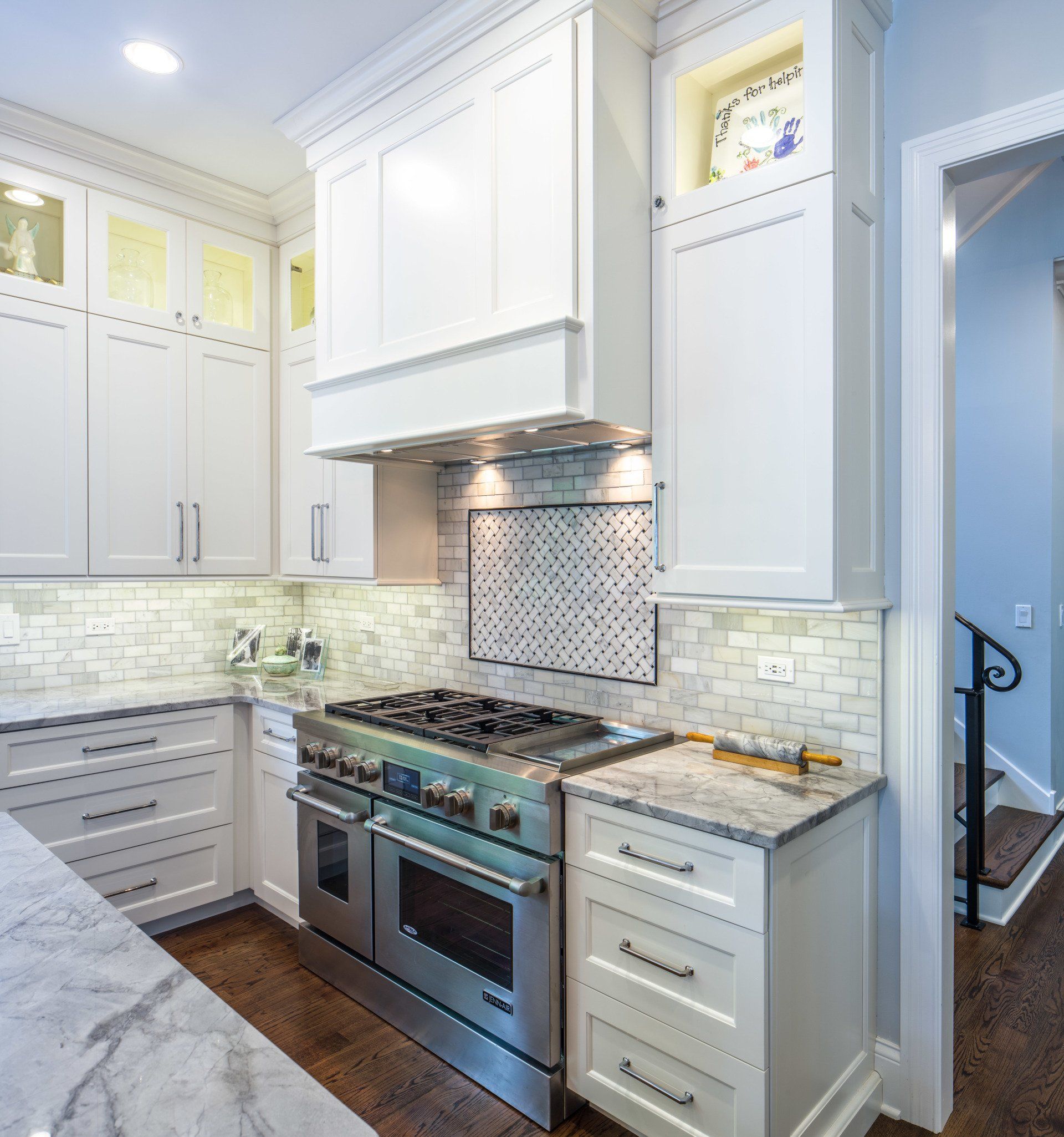 A kitchen with stainless steel appliances and white cabinets