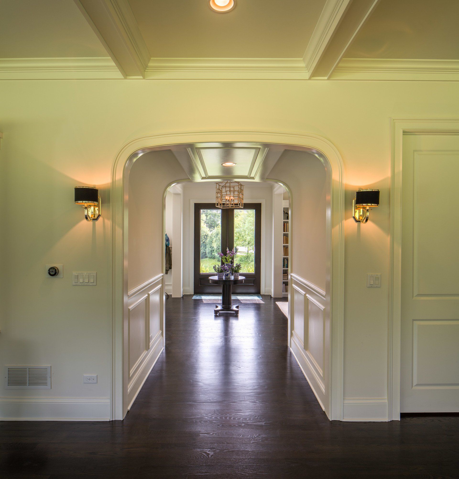A hallway in a house with a table in the middle