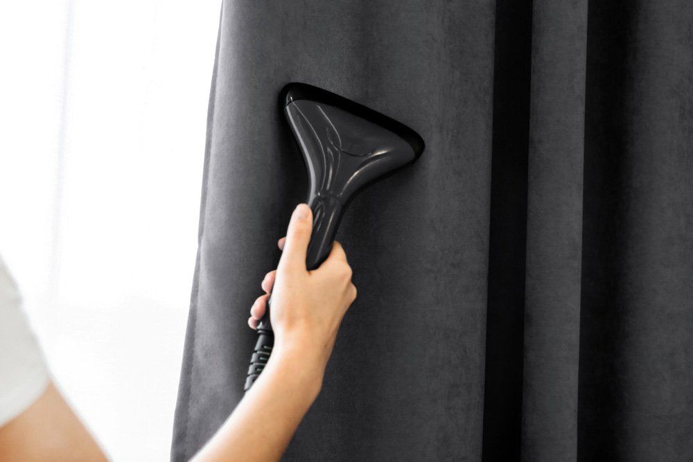 Holds a steamer for curtains — Window Furnishing Services in Tweed Heads, NSW