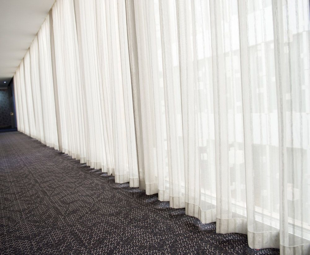 Hotel Corridor with Long White Curtains — Window Furnishing Services in Kingscliff, NSW