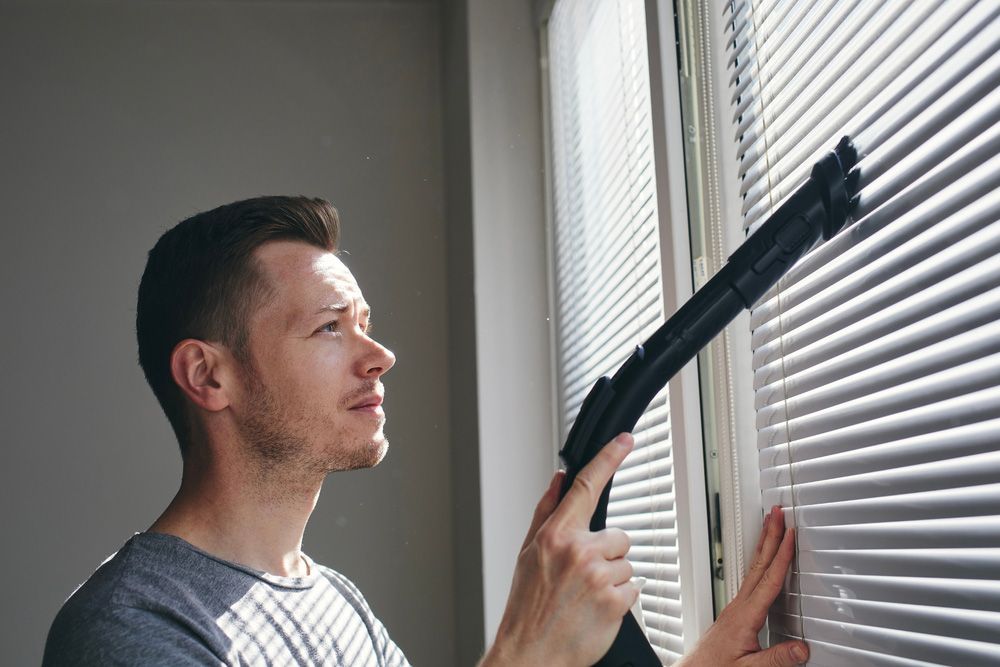 Man Cleaning Blinds — Window Furnishing Services in Tweed Heads, NSW