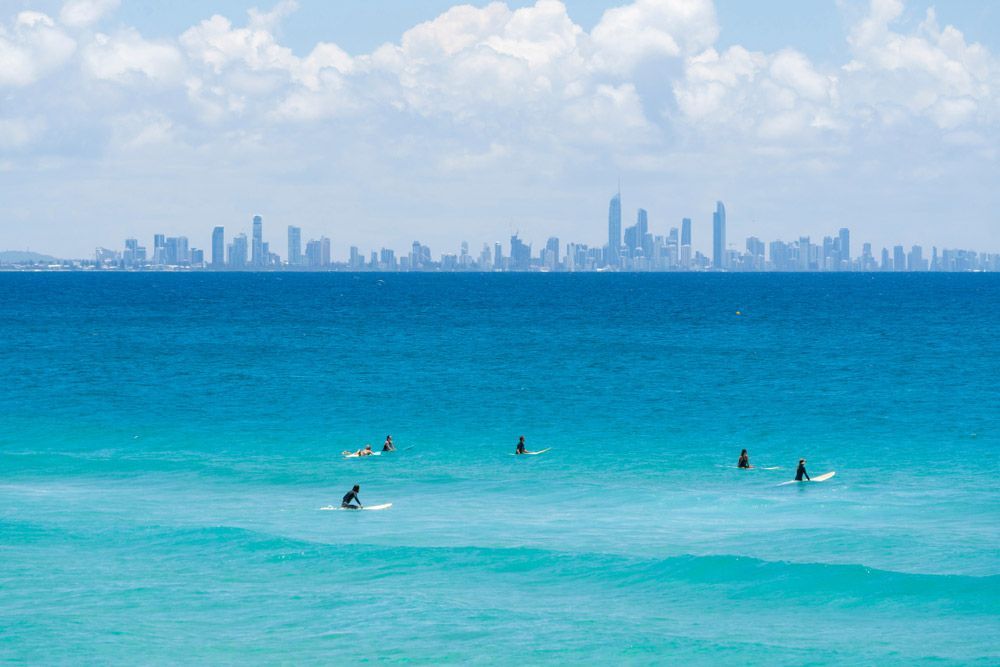 Surfers Sit on Their Boards — Window Furnishing Services in Gold Coast, NSW
