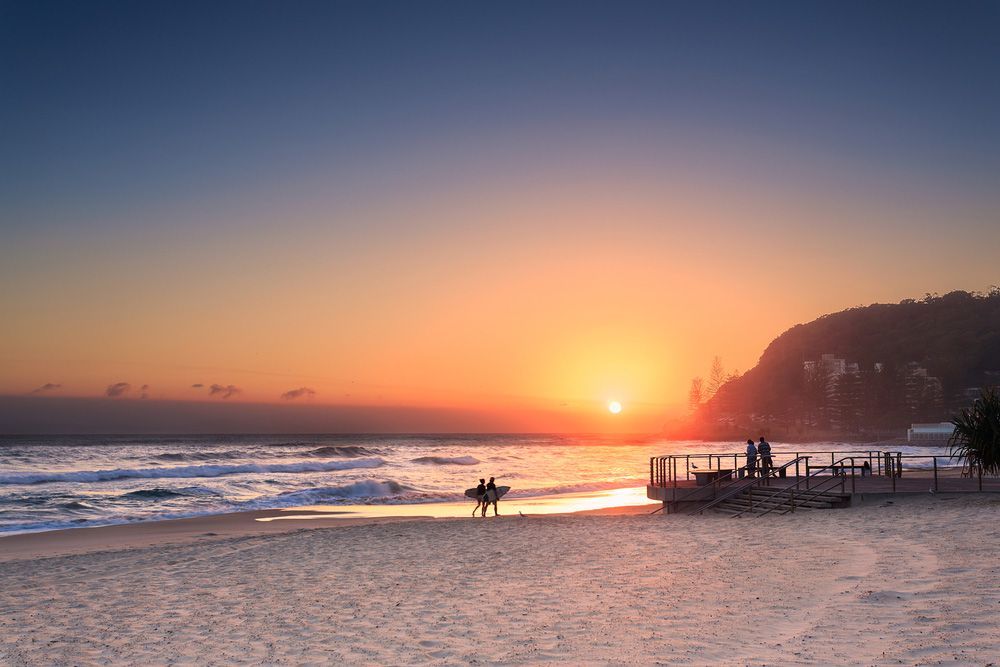 Surfers Walking in a Beach in Burleigh Heads — Window Furnishing Services in Burleigh Heads, NSW