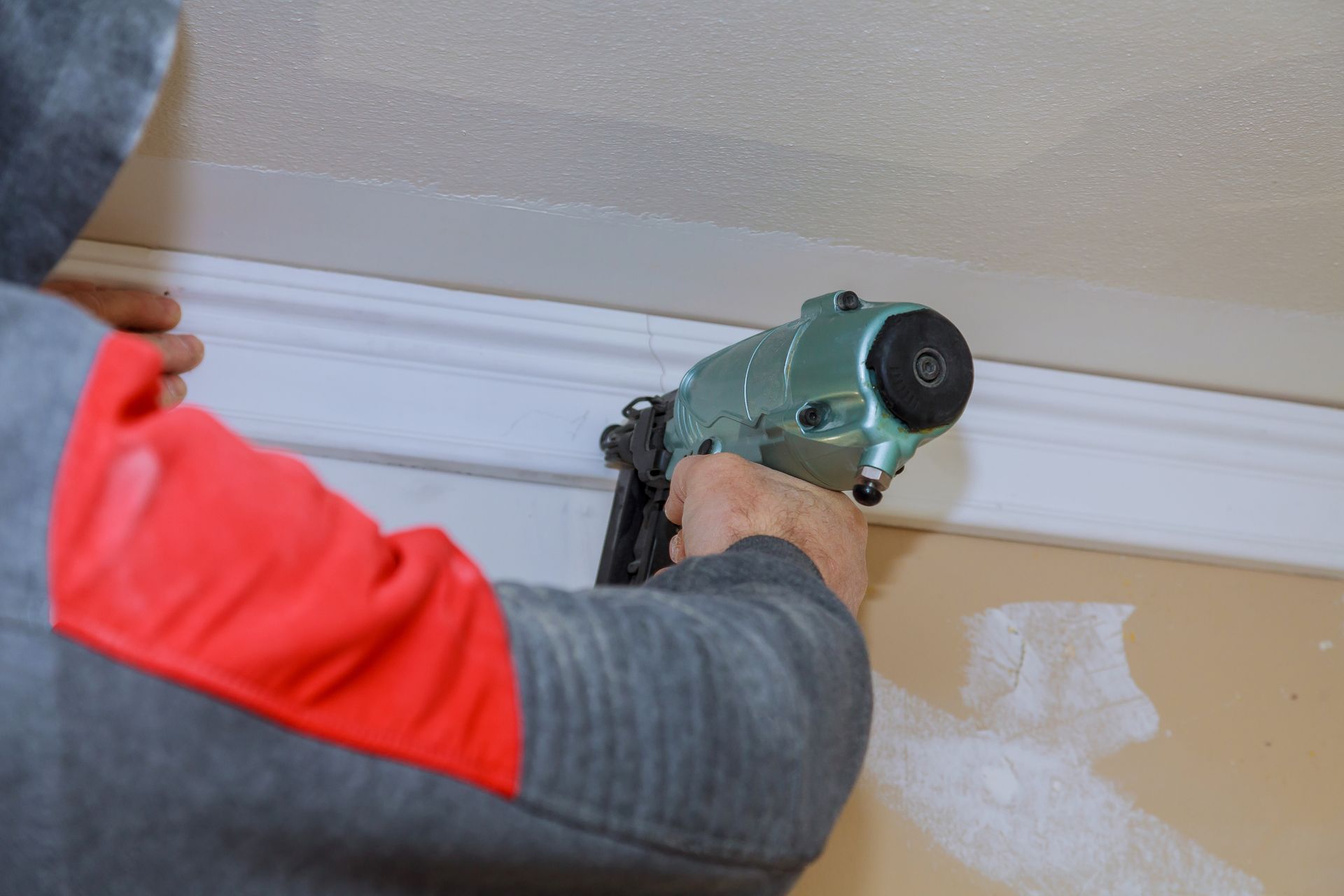 A professional handyman repairing a damaged ceiling.