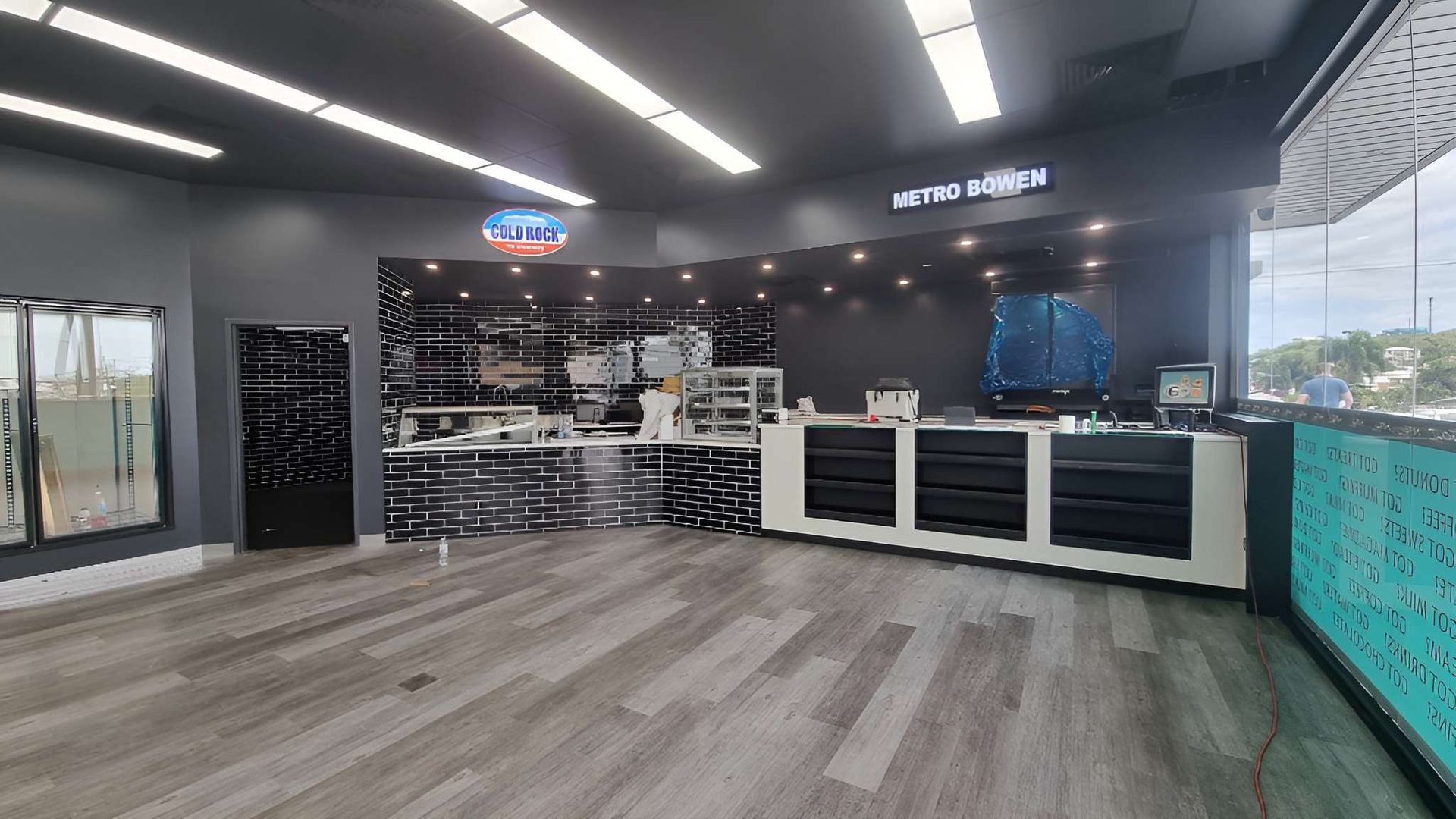 A Large Empty Room With a Wooden Floor and a Counter in a Restaurant — Kristal Kleen Services in Jubilee Pocket, QLD