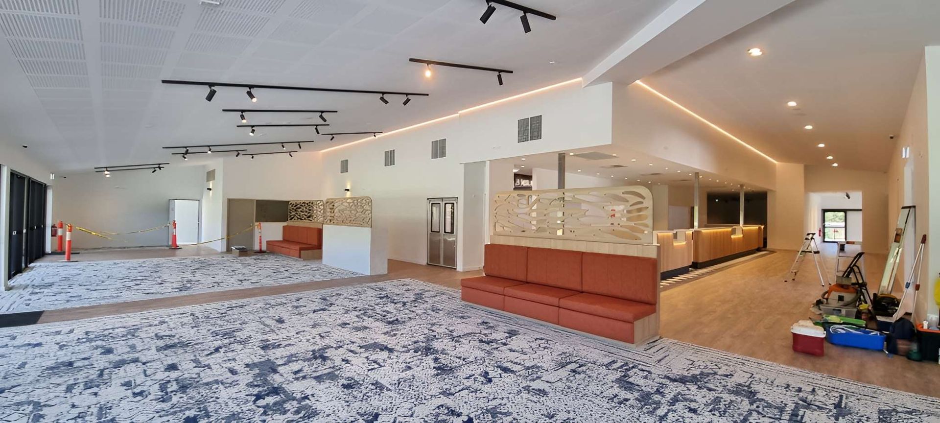 A Large Empty Room With a Carpeted Floor and a Couch — Kristal Kleen Services in Jubilee Pocket, QLD