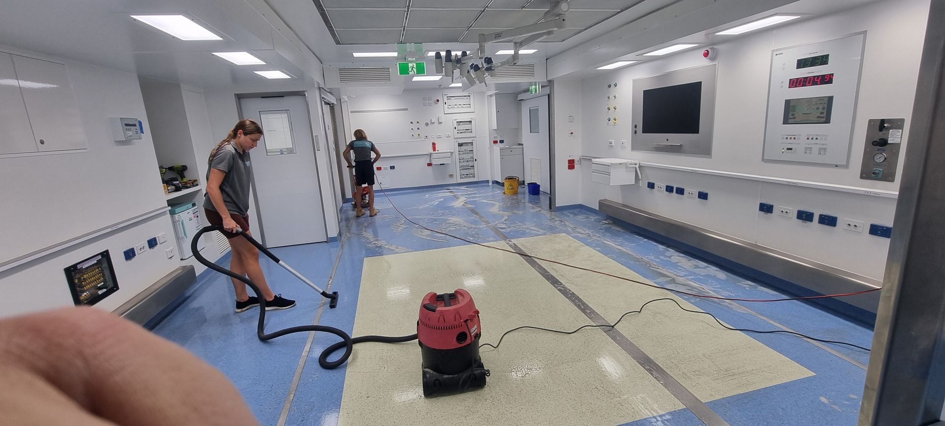 A Person is Using a Machine to Clean a Granite Floor — Kristal Kleen Services in Jubilee Pocket, QLD