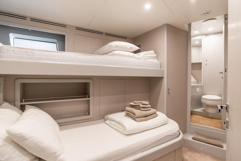 A Bedroom on a Boat With Bunk Beds and a Toilet — Kristal Kleen Services in Jubilee Pocket, QLD