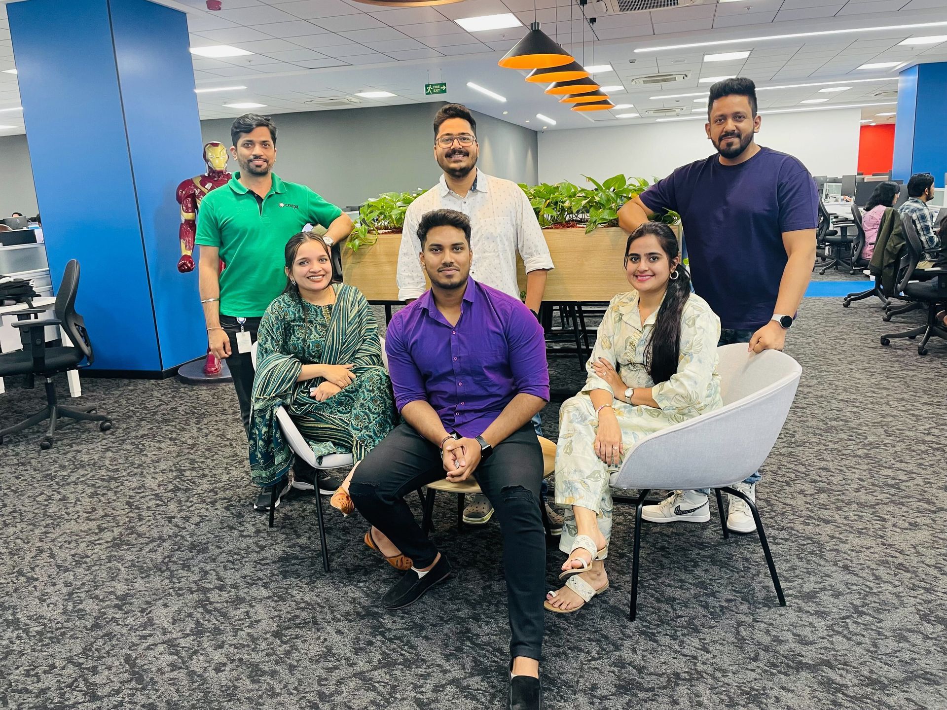 Office photo of India team members sitting in the chairs