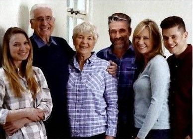Family portrait, indoors. Six people: grandparents, adults, young adults, smiling, posing. Family portrait, indoors. Six people: grandparents, adults, young adults, smiling, posing.