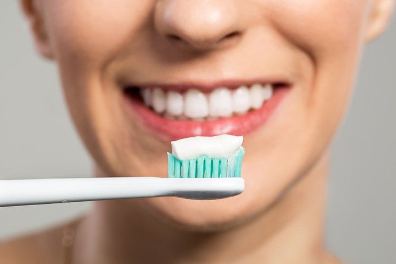 Comprehensive Dental — Clening Teethi with Toothbrush and Toothpaste in Albuquerque, NM