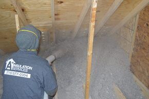 Man Spraying a Room — Eau Claire, WI — A+ Insulation Services