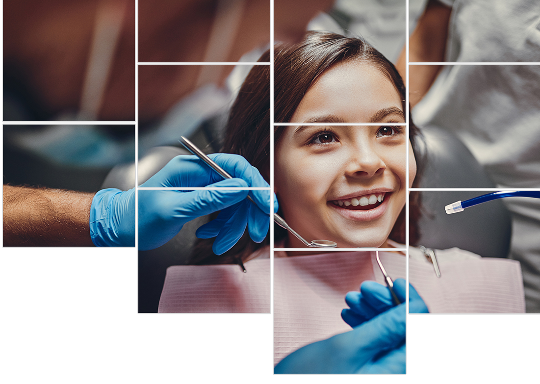 A young girl is sitting in a dental chair while a dentist examines her teeth.