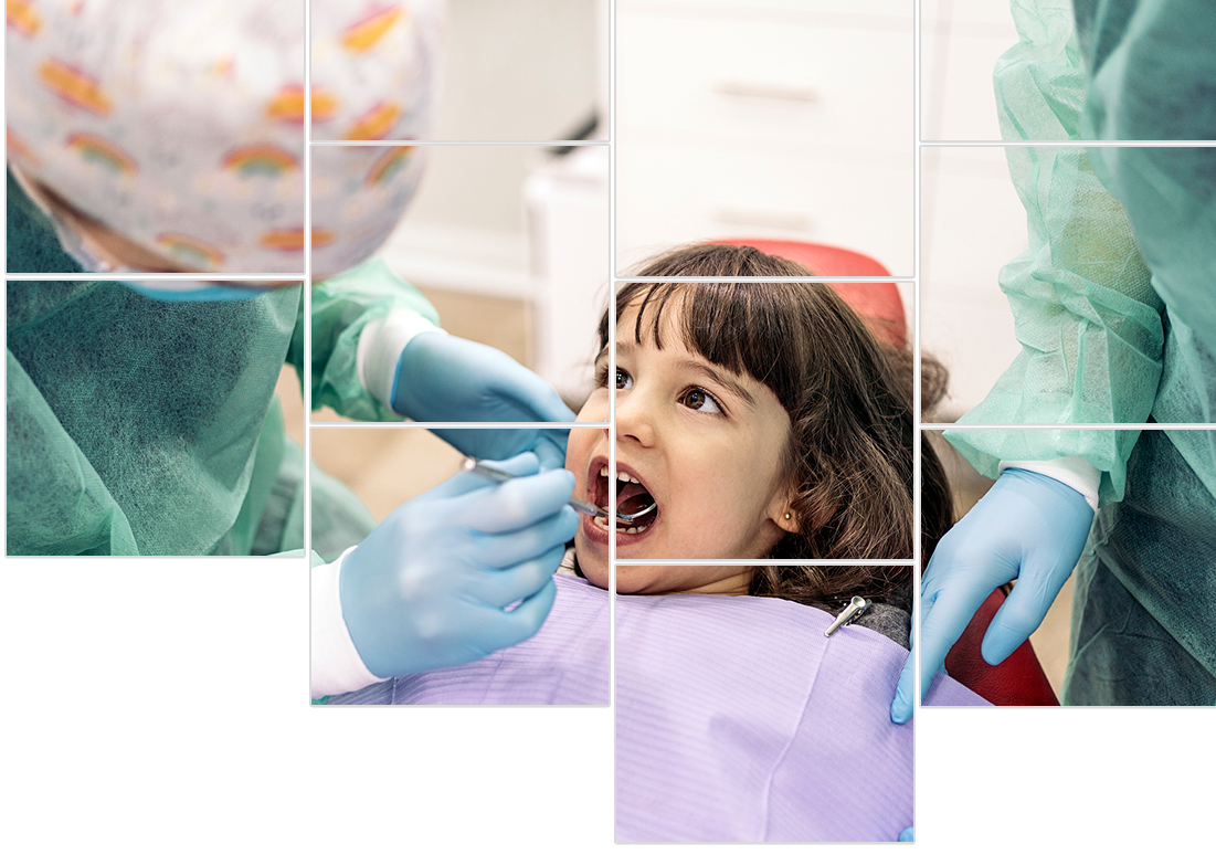 A little girl is getting her teeth examined by a dentist.