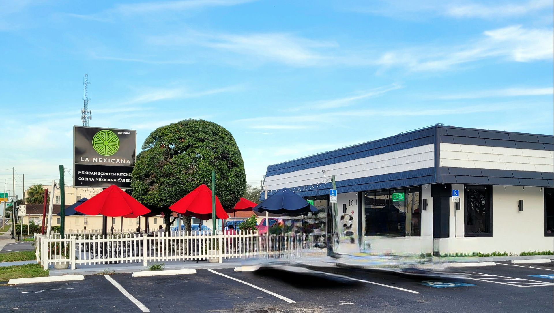 A restaurant with red umbrellas in front of it